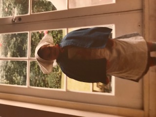 Young child standing in front of window